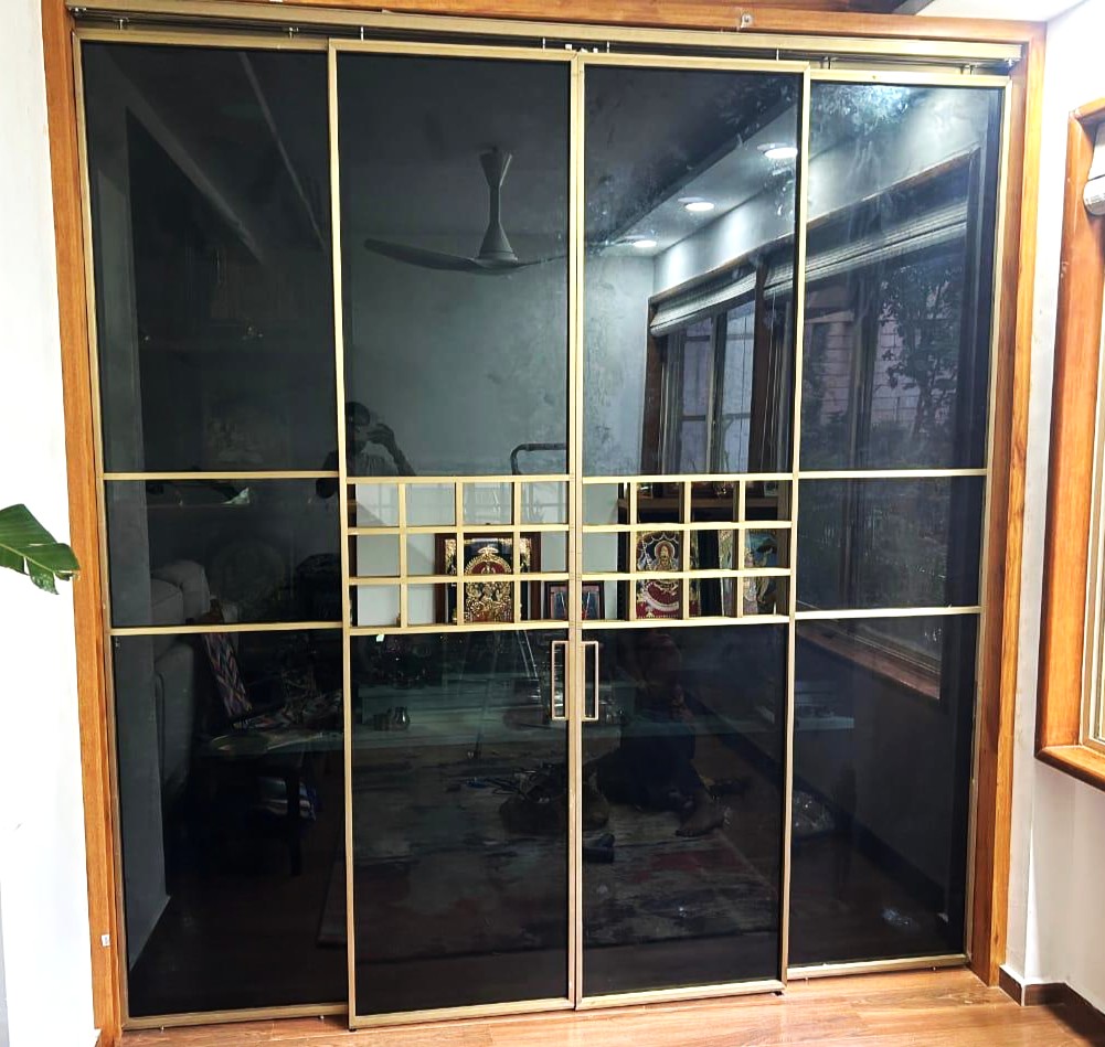 Slim-framed glass and metal partition doors fitted between two rooms