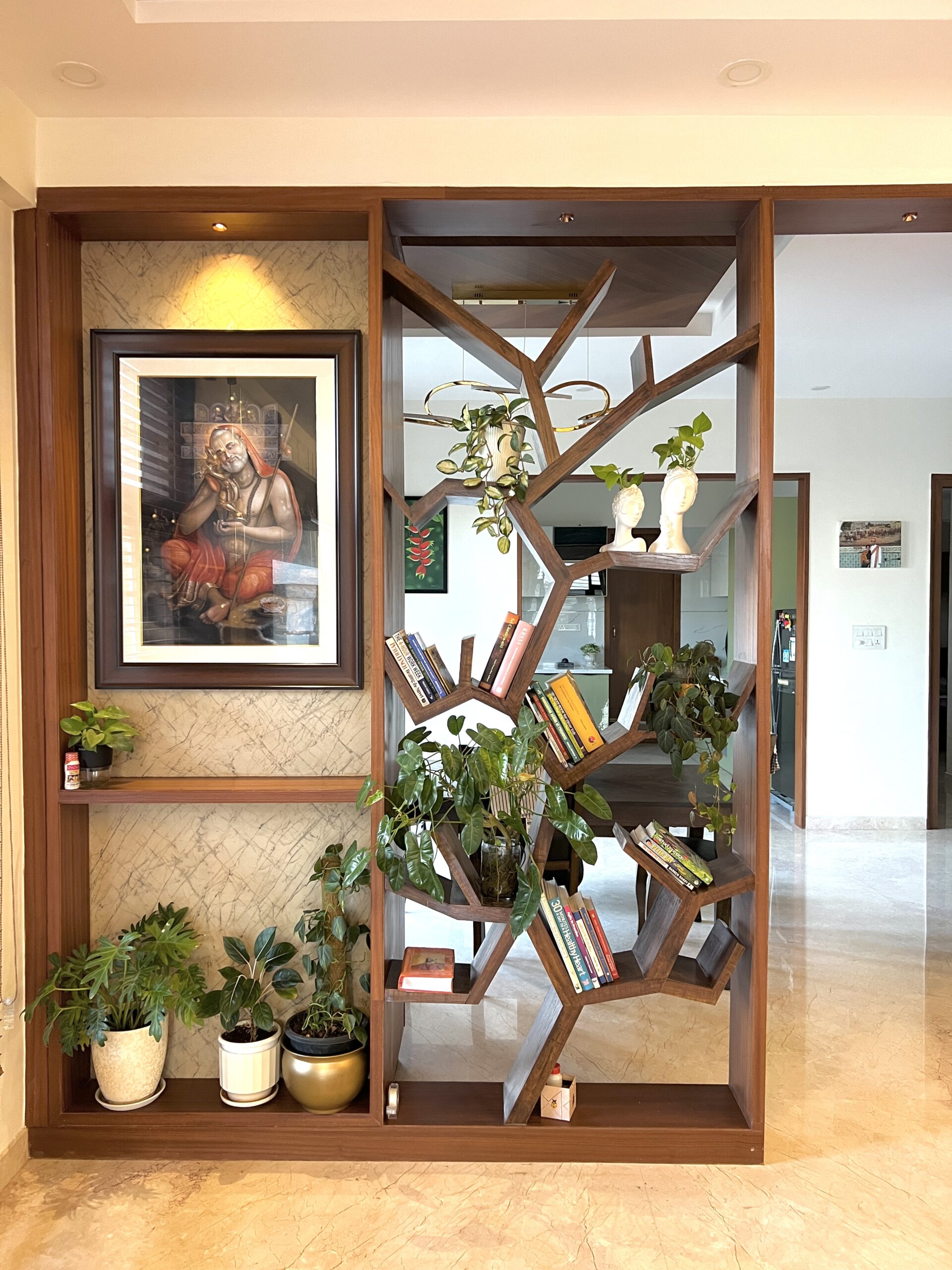 Bespoke timber partition with integrated shelving separating the living and dining spaces