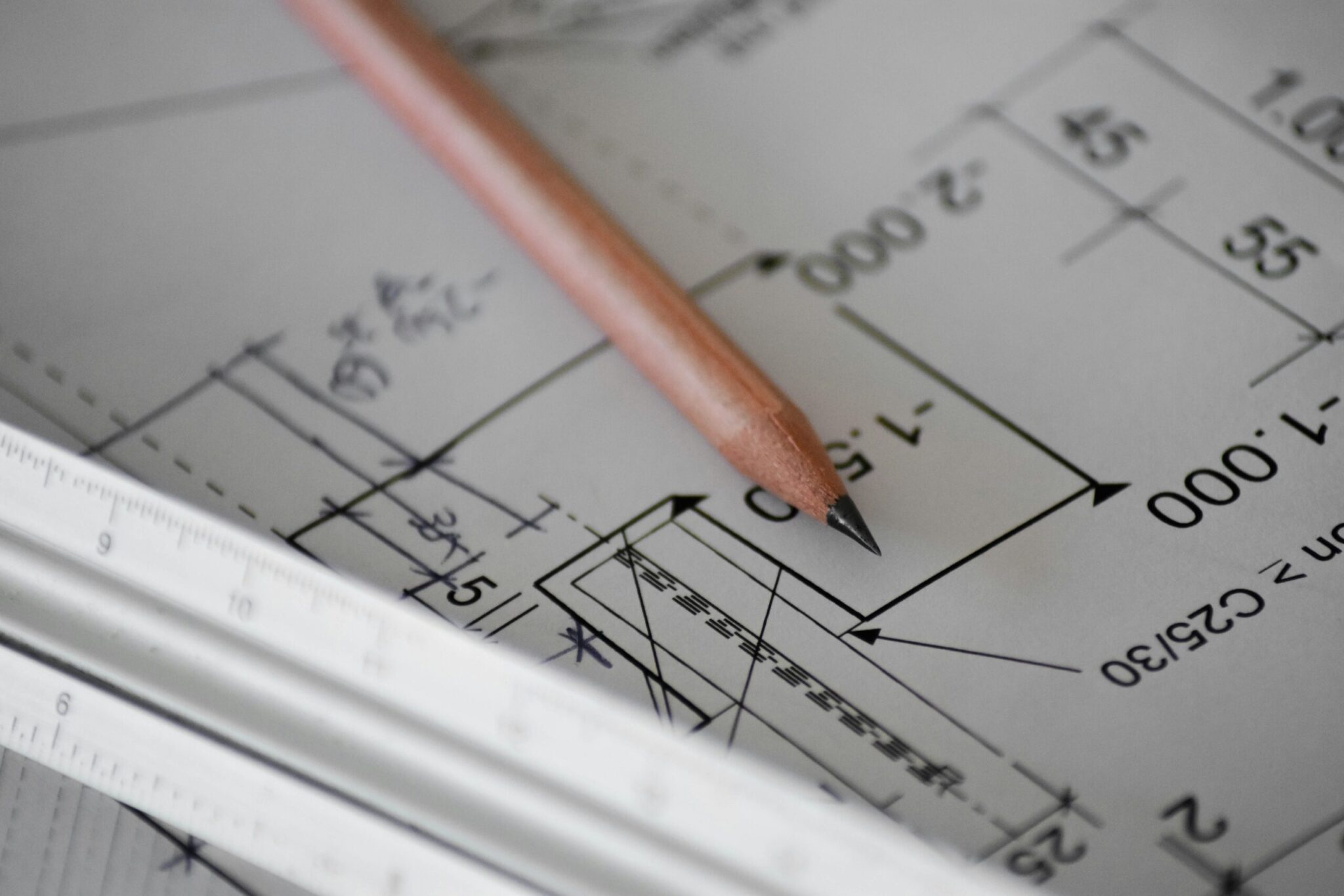 Architectural drawing board with technical plans, scale rule and drafting instruments
